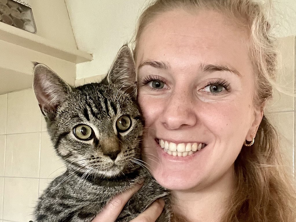 A person holding a cat.